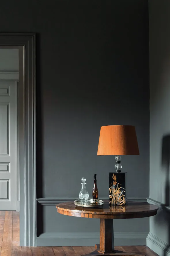 dark blue grey painted wall in a matt finish
